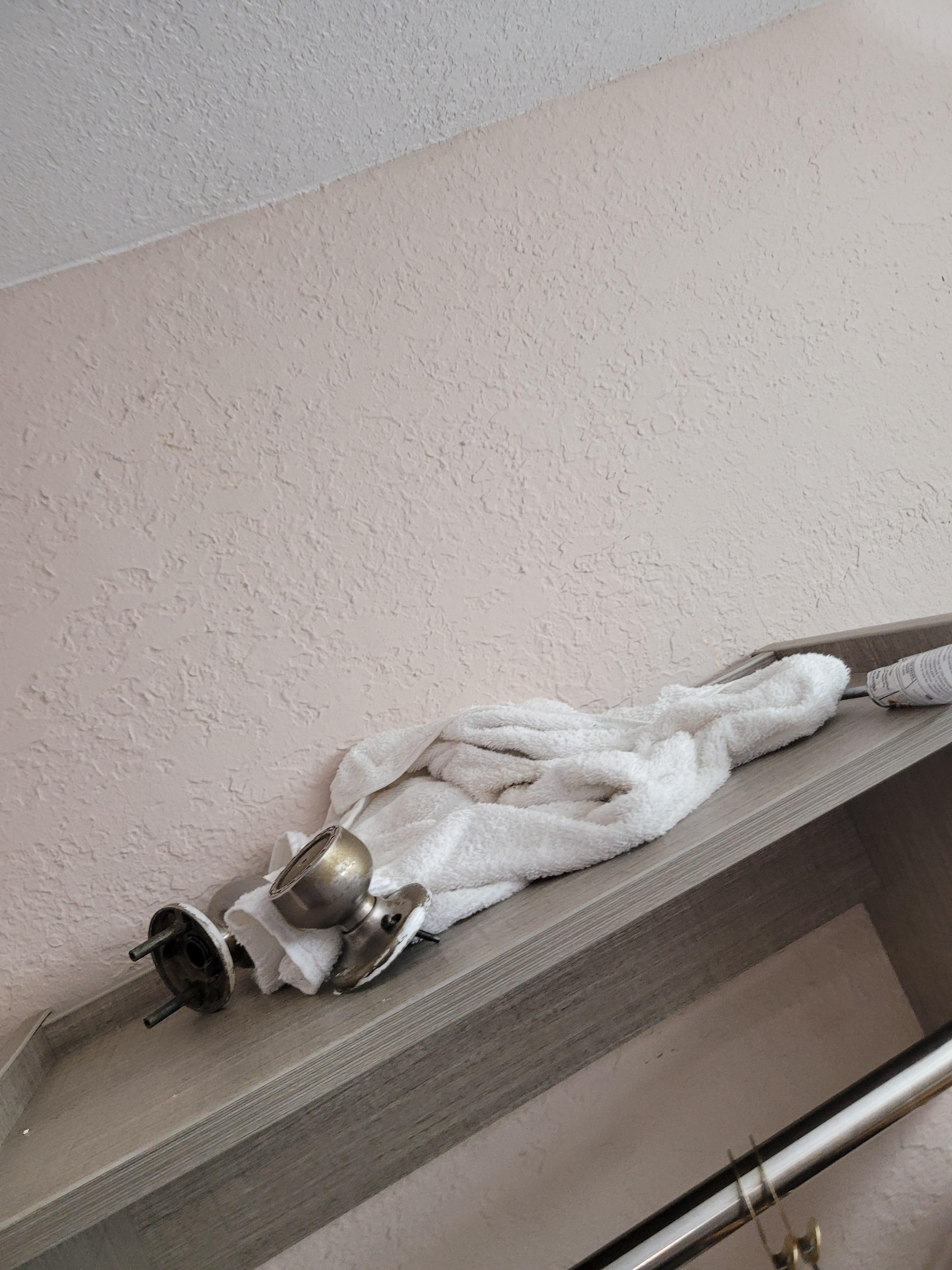 Tools, dirty rags and door knob parts.