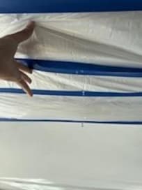 Hole in the ceiling of the living room, covered only with plastic and duct tape, leaking all weekend