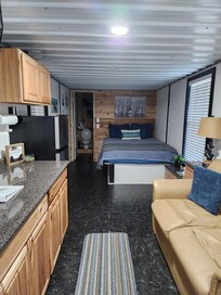 Big TV , in front of the couch, on the wall