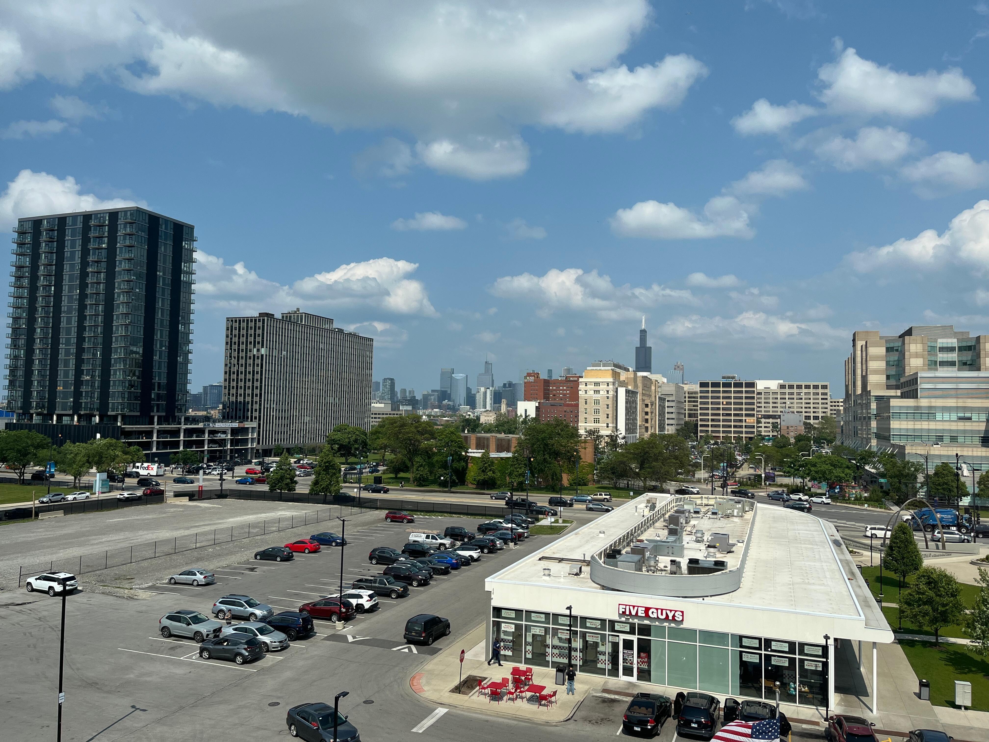 View out the window of the city skyline and shopping mall with eating venues.