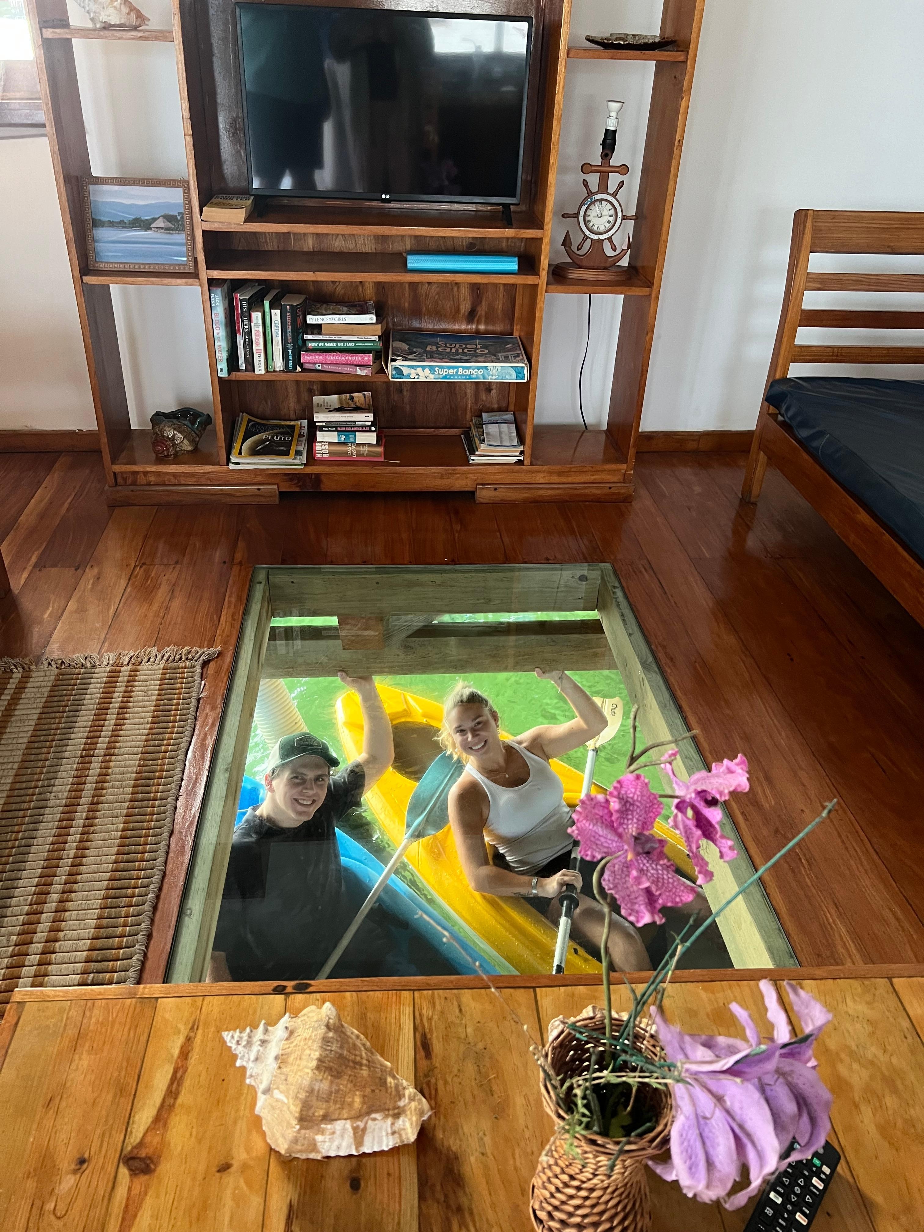 Watching the Kids enjoying the kayaks through the glass floor in the living room. 