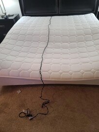 Front view: I laid an extension cord so you can see how broke the mattress was. I'm not sure if the photo does it justice, but it was very hard to sleep on