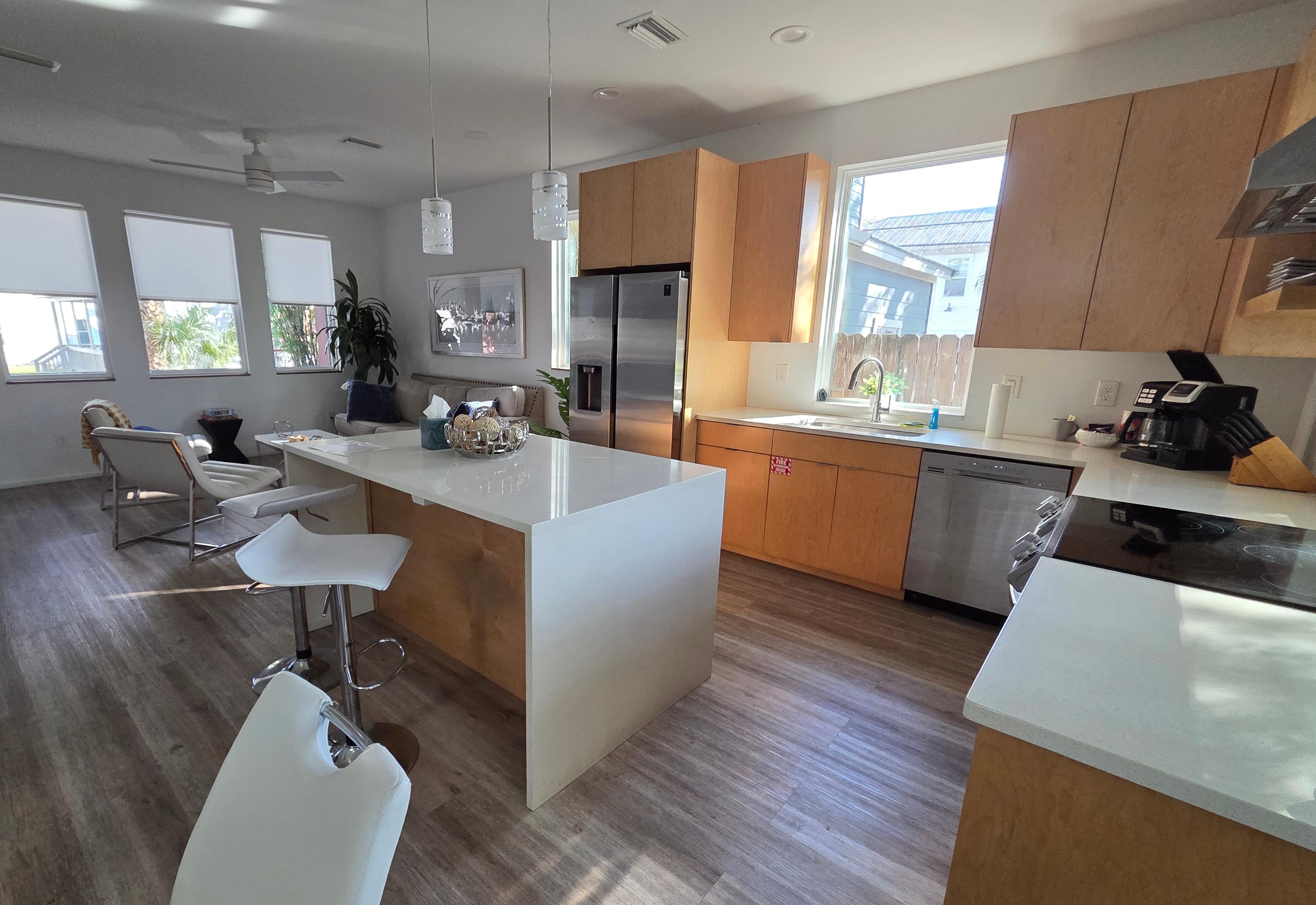 Open kitchen and living room with great windows.