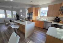 Open kitchen and living room with great windows.