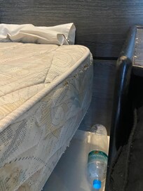 Closer view of wear and holes in mattresses.