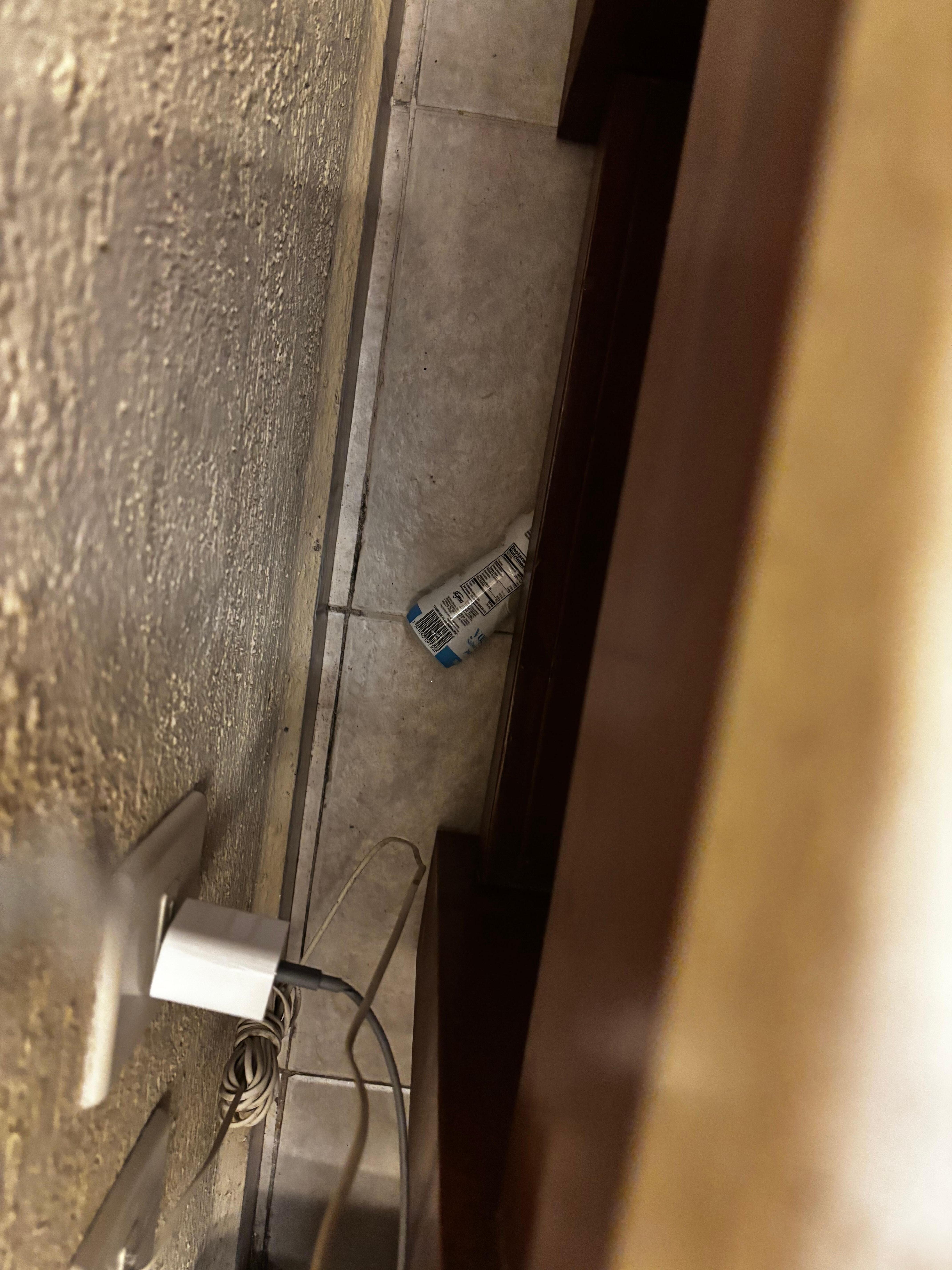 Yogurt bottle behind nightstand they do not clean the rooms thoroughly