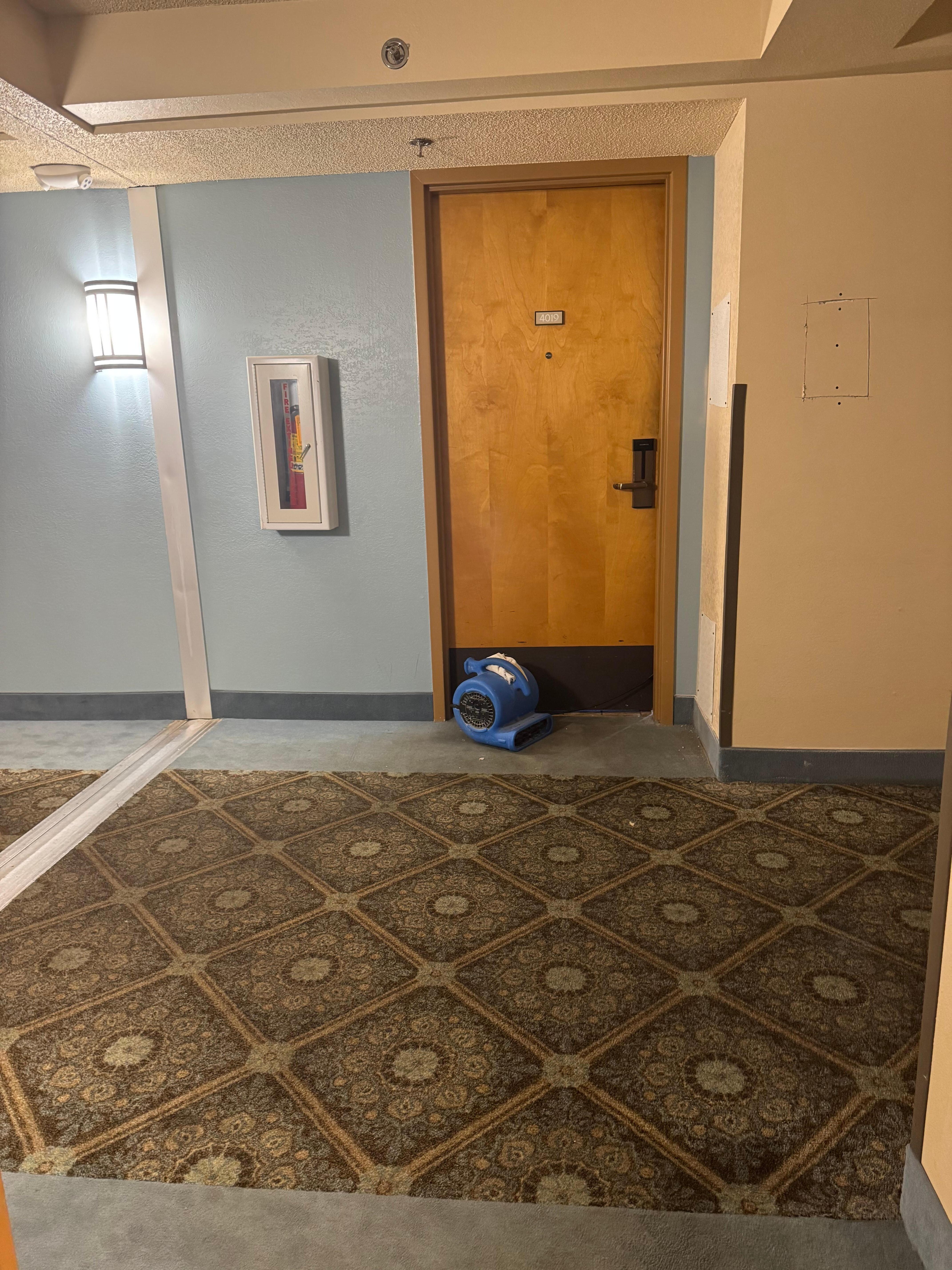 Across the hall. Fan ran 24 hours. The smell was terrible.