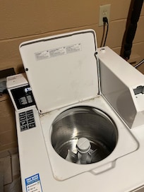 My empty washer after having to reach in and pull out piss clothes covered in powdered laundry detergent.