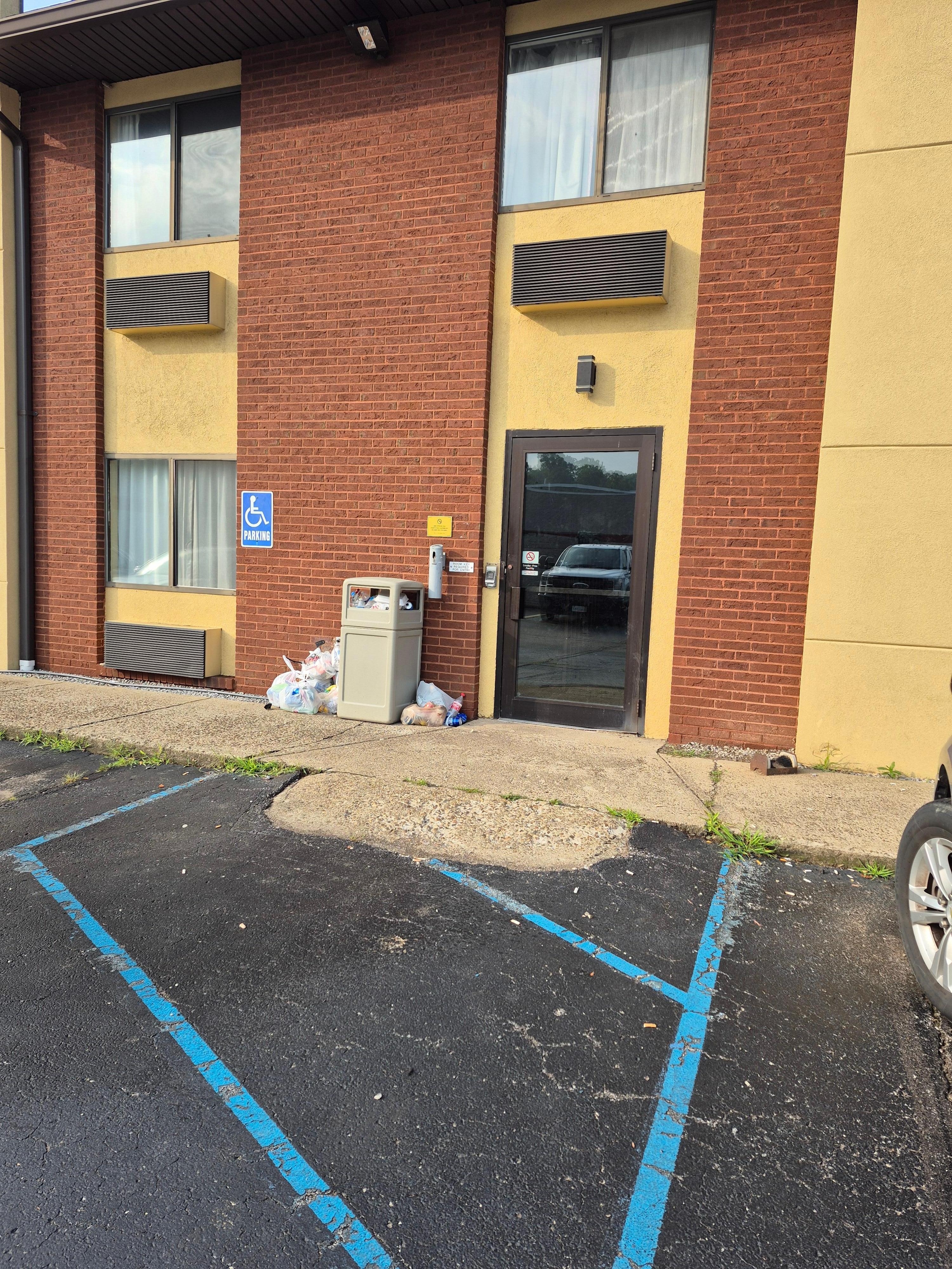 The trash can was running over onto the sidewalk by the door people use to come and go.  Employees smoked by that door and just stood around the trash.