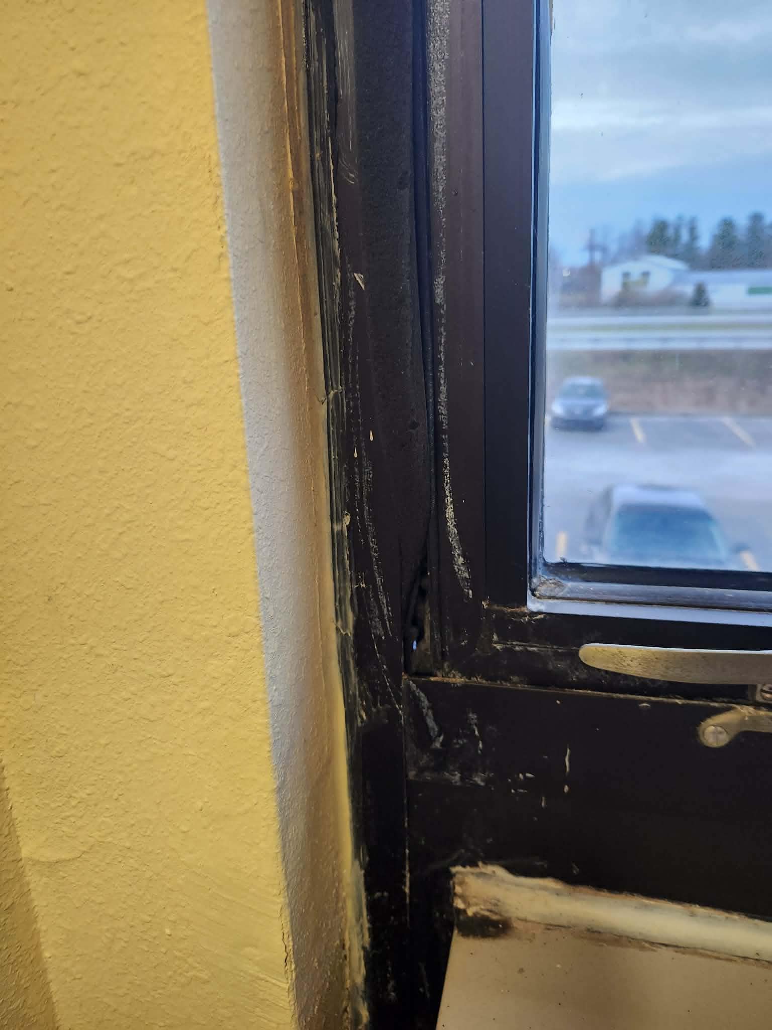 Hole through the wall and window frame. Allowing weather and street noise in.