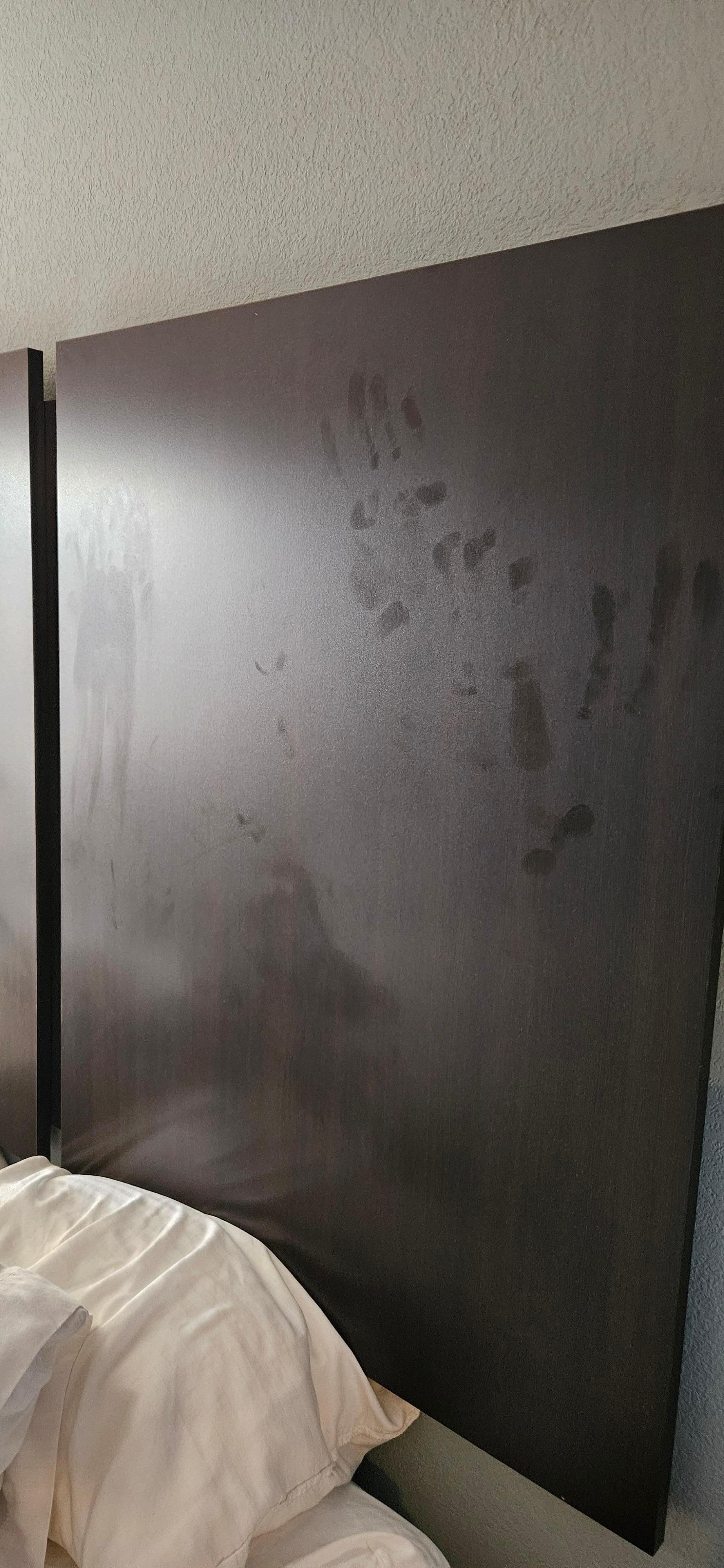 Handprints on headboard upon our arrival to room