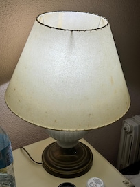 Lamp in front of bed