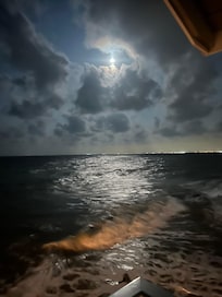 Moon shining on the water from the deck.