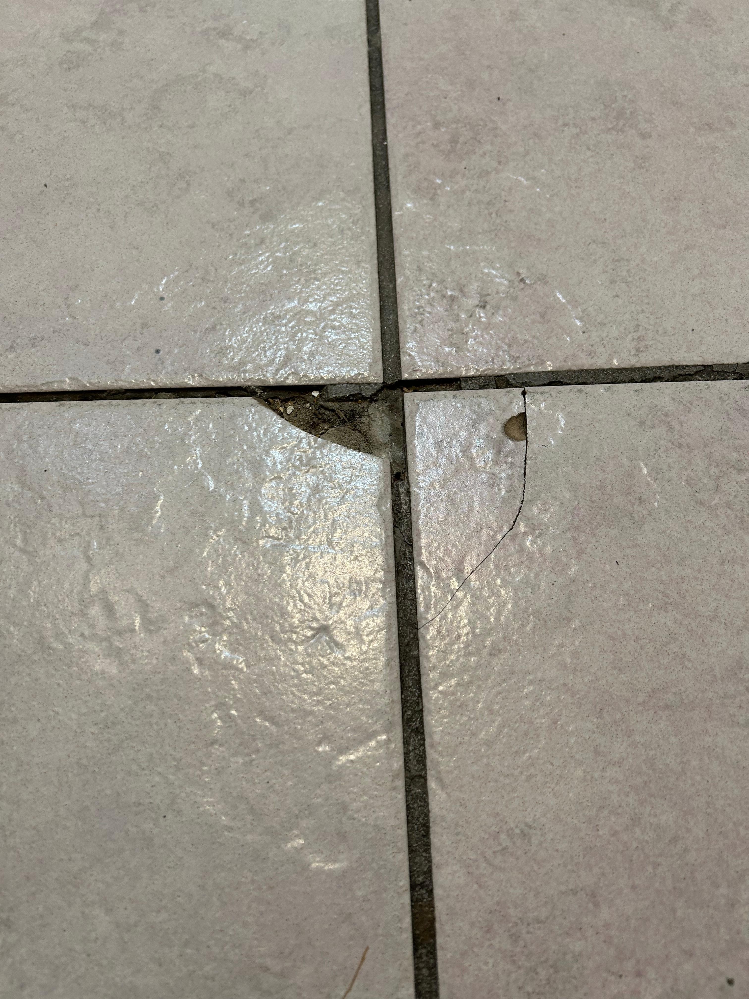 Broken floor tile in kitchen
