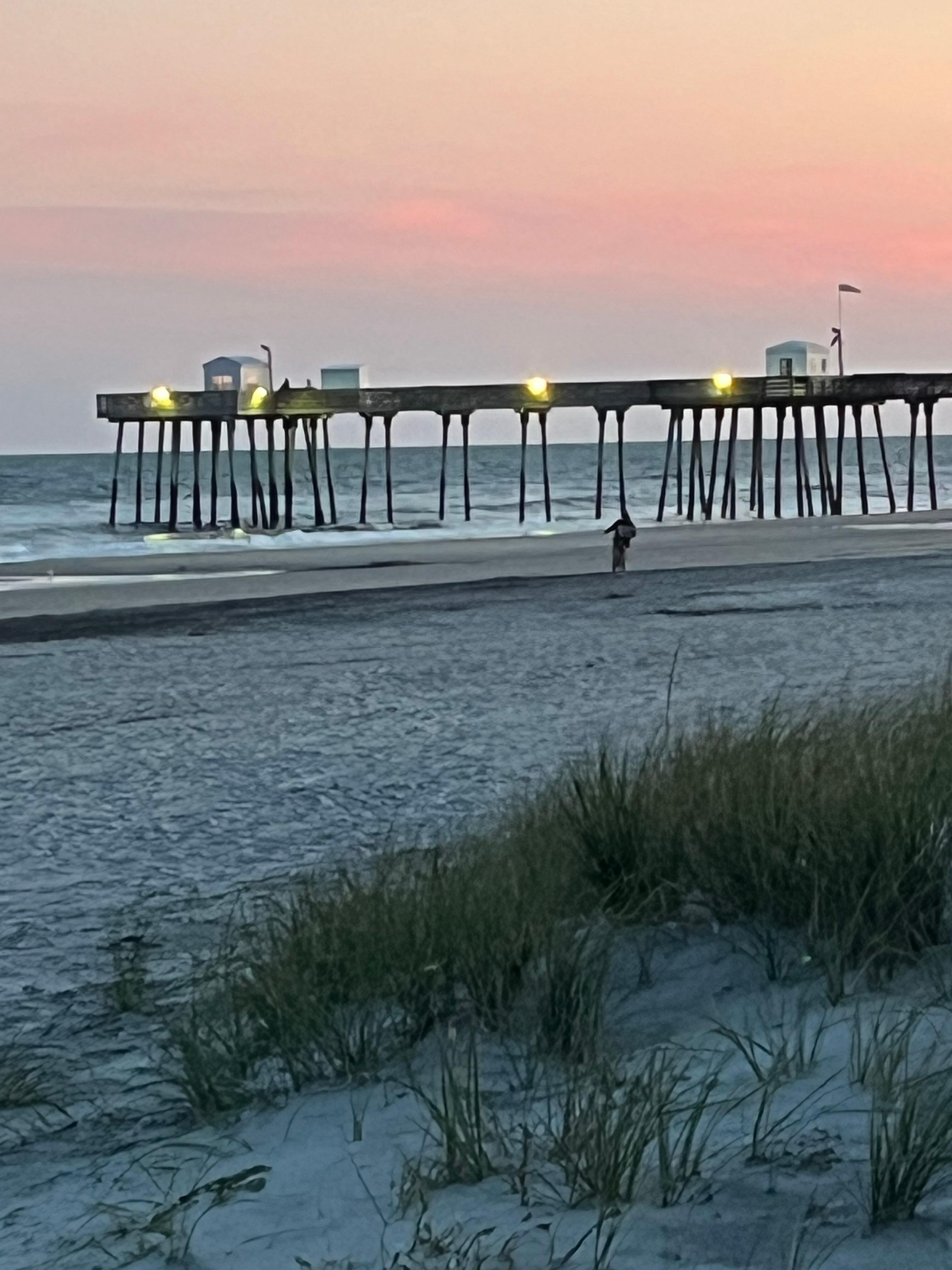 Sunset over a pier off the Wildwood boardwalk Pier