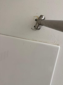 Shower curtain barely hanging on