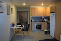 View of main room. Bed room is far back and very small bathroom behind stove/oven. No windows in bedroom. Bathroom door needs to be closed to use sink.