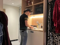 My spouse making me a cute sandwich in our kitchenette, which also had a stove top so we could cook together