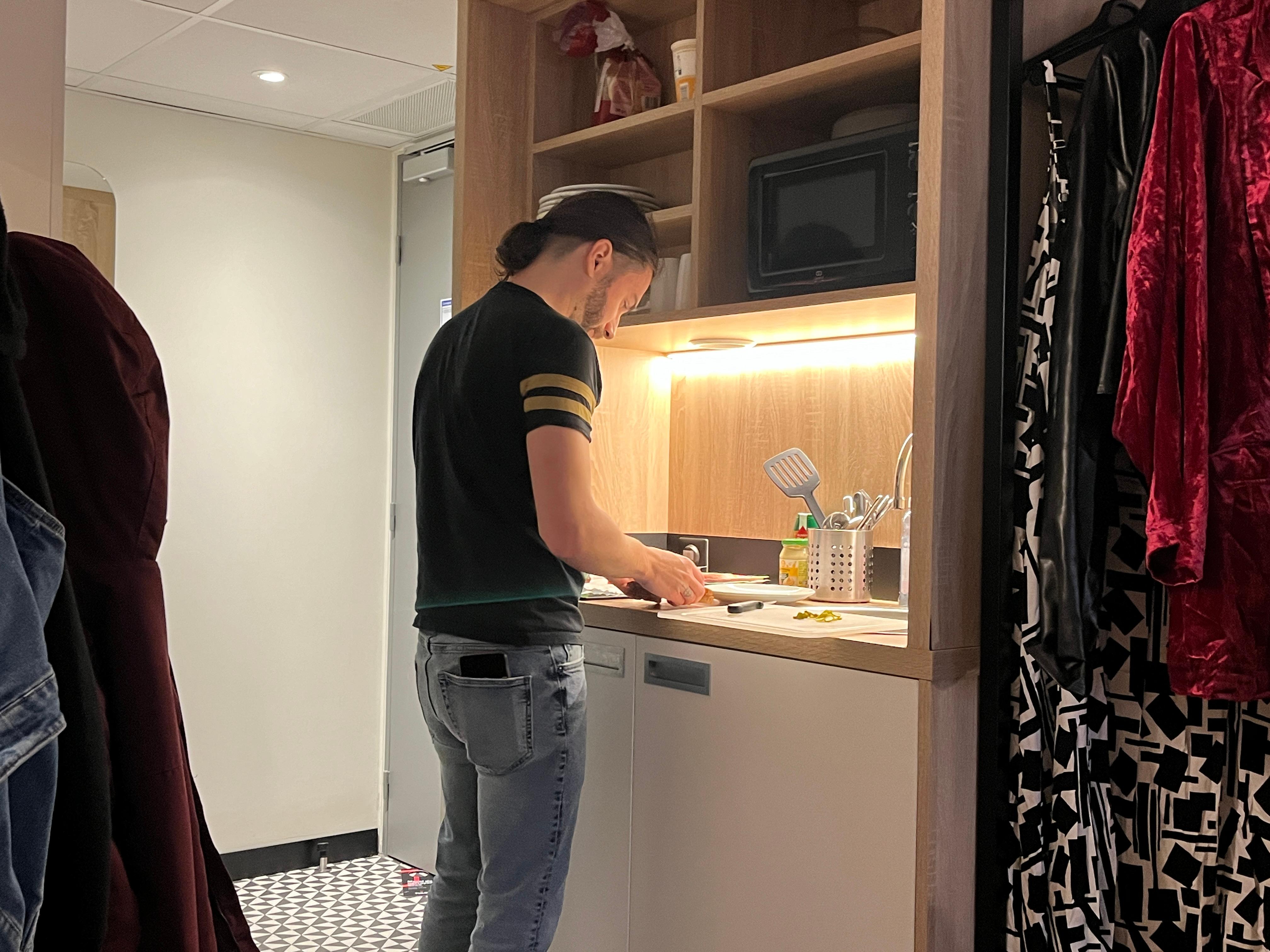 My spouse making me a cute sandwich in our kitchenette, which also had a stove top so we could cook together