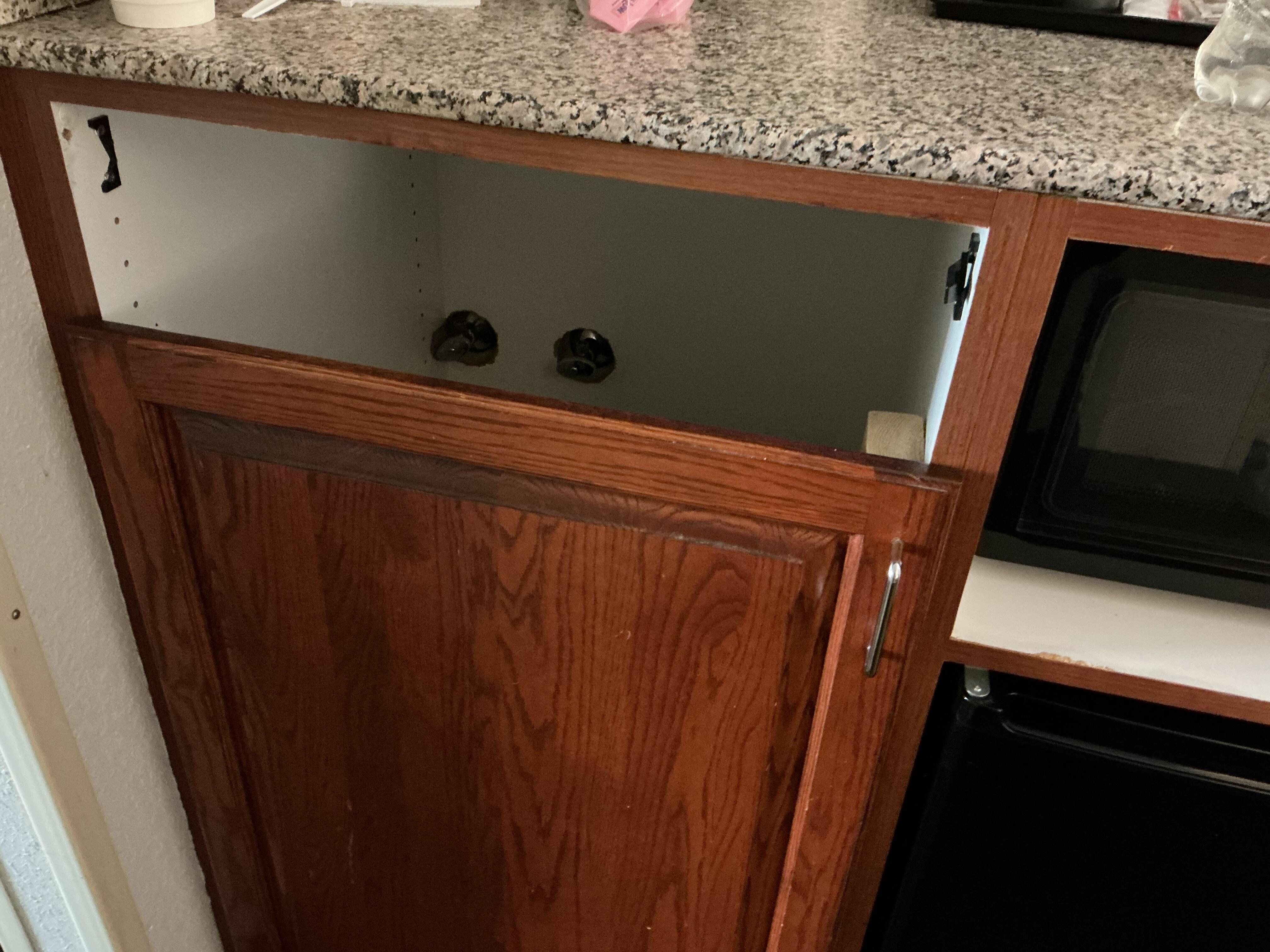 Missing drawer in microwave/refrigerator cabinet.