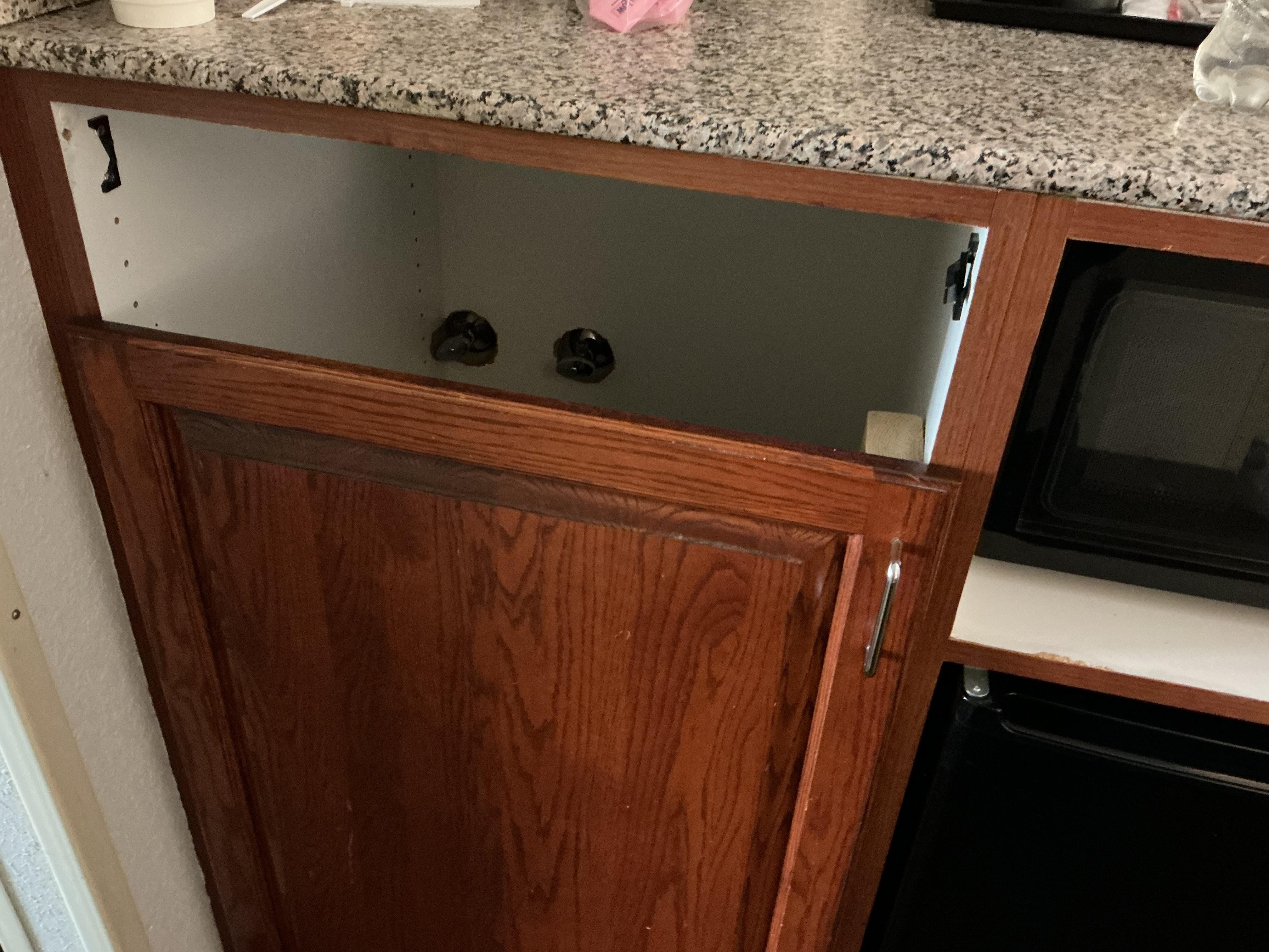 Missing drawer in microwave/refrigerator cabinet.