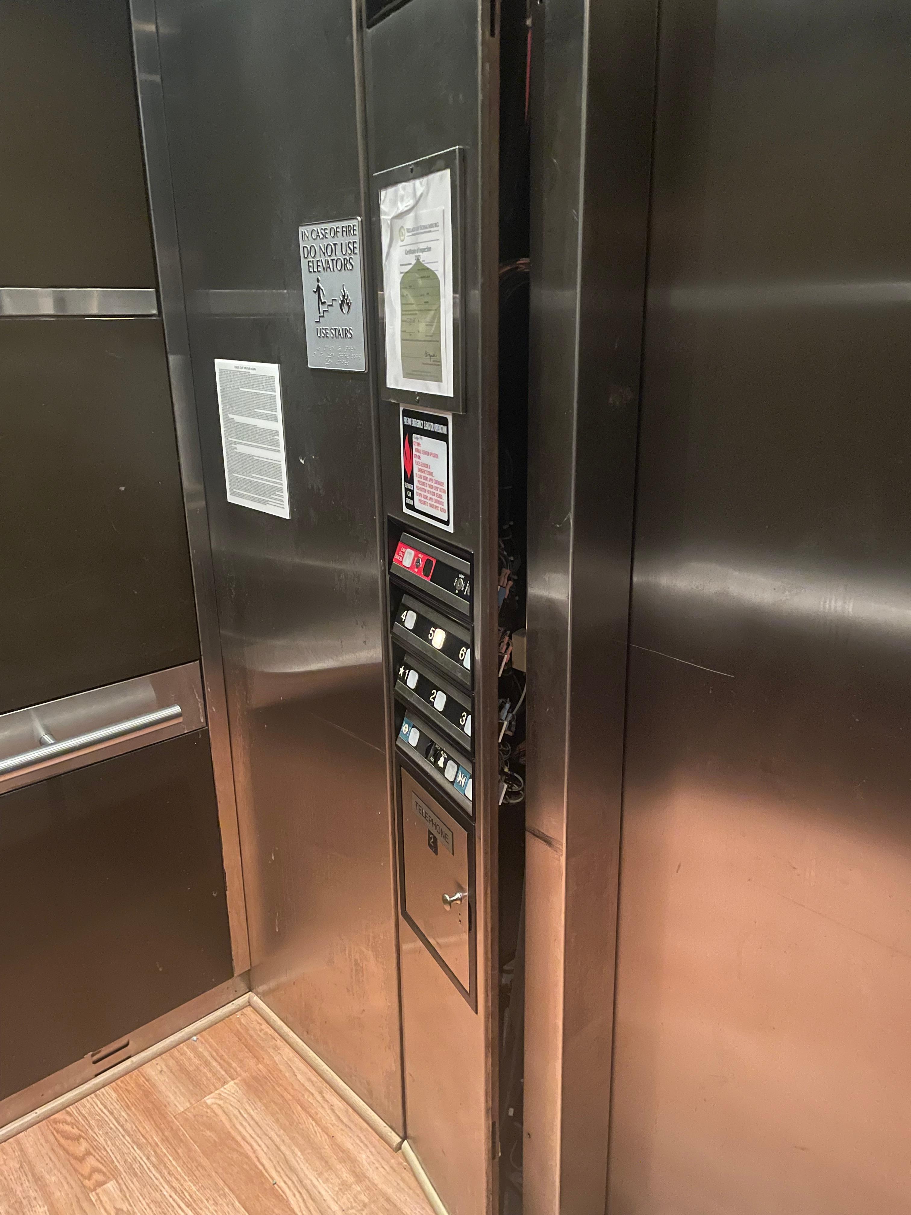 This is in the elevator. This electrical panel door was closed as much as I could get it. 