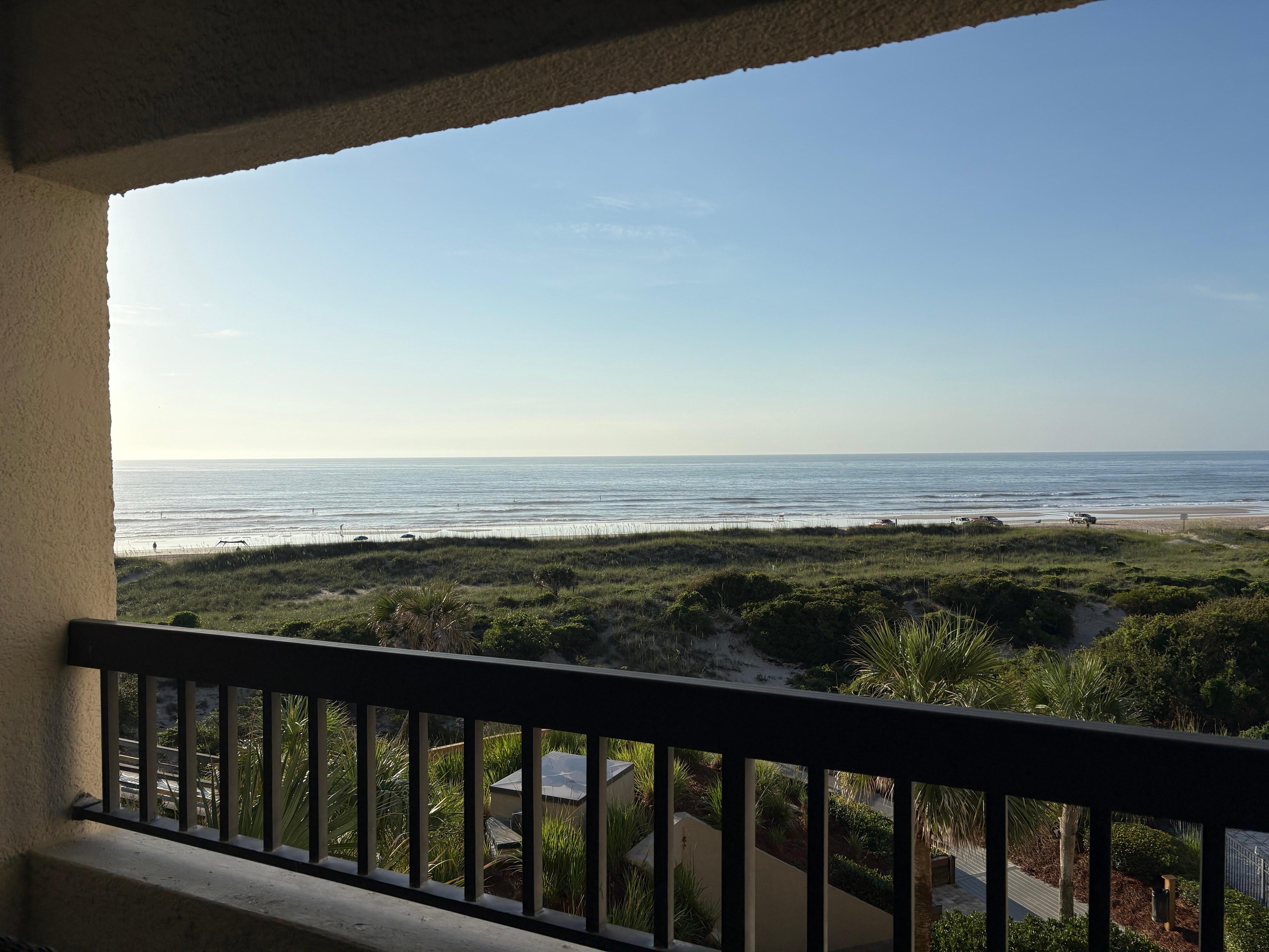 Morning on the balcony, watching the SUPs on the quiet ocean.