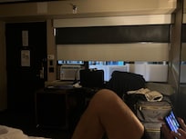 Room with shades down to shut off the guests traffic in the hallway.