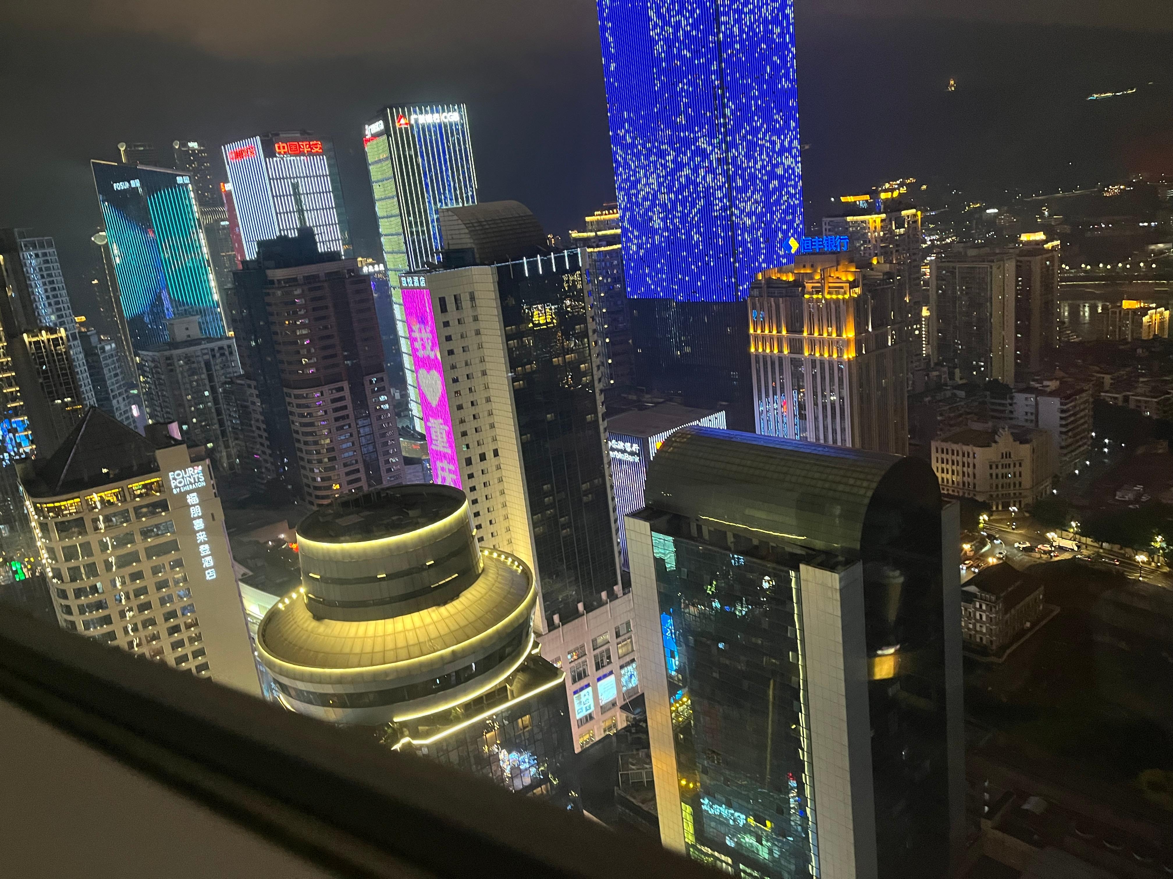 View at night of Chongqing out my rooms glass wall 