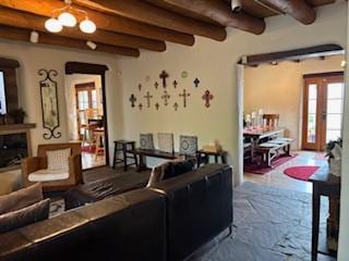 Lovely living area with large TV and entry and dining to the right and kitchen and outdoor patio to the left.