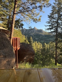 Pictured is the view from the dining room table, looking through the window past the deck.