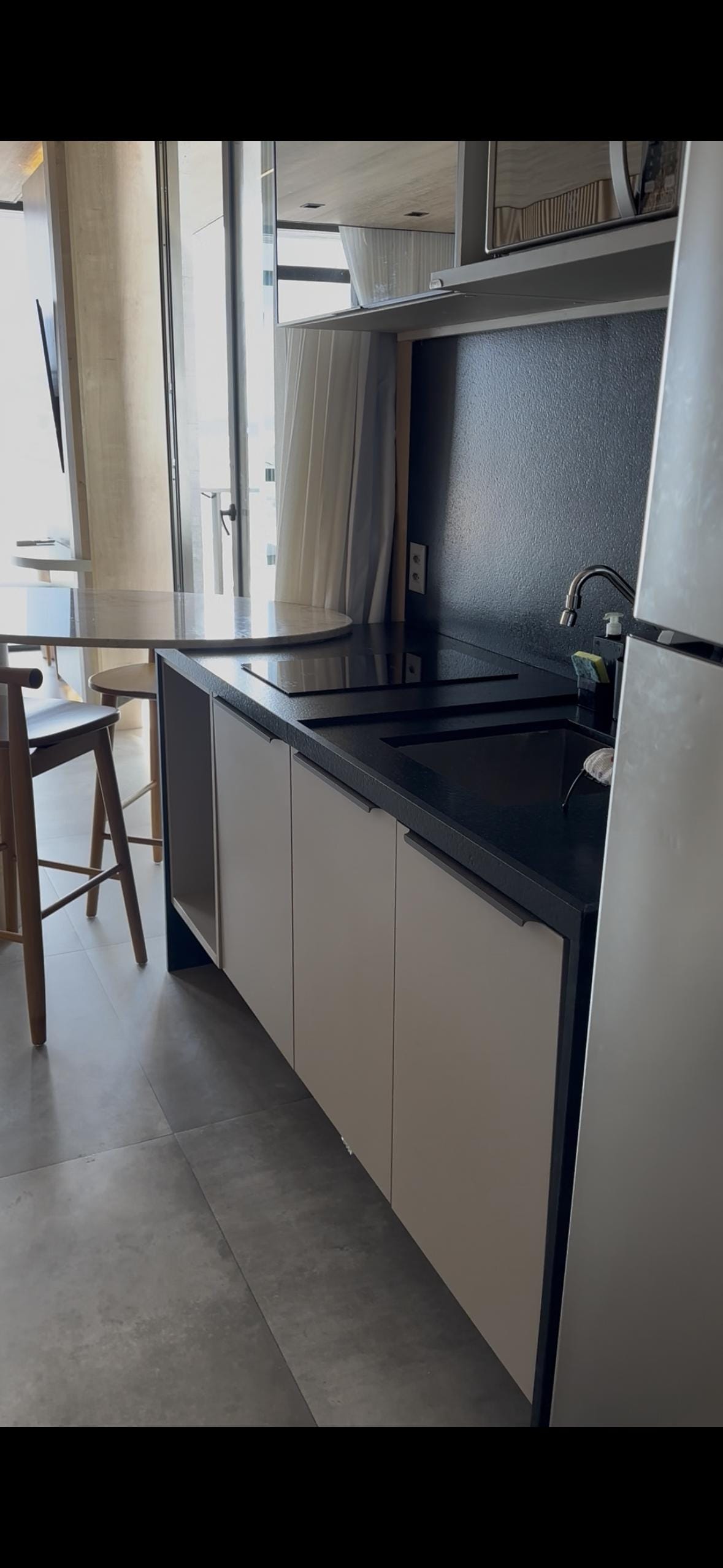 Entrada do apartamento, equipado com geladeira, fogão por indução, mesa, completinho