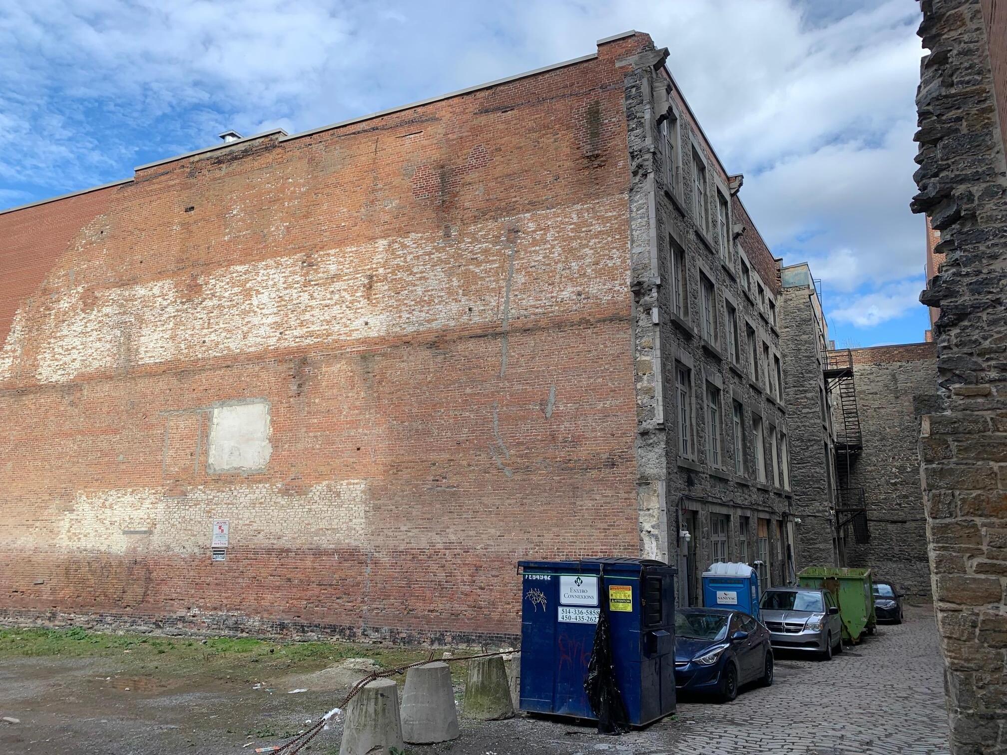 This is the building and suite windows look out into this alley which was quite noisy with workers and folks starting cars in an 'echo-chamber'.