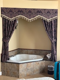 A big soaker tub looking at the fireplace added to the romantic ambiance.