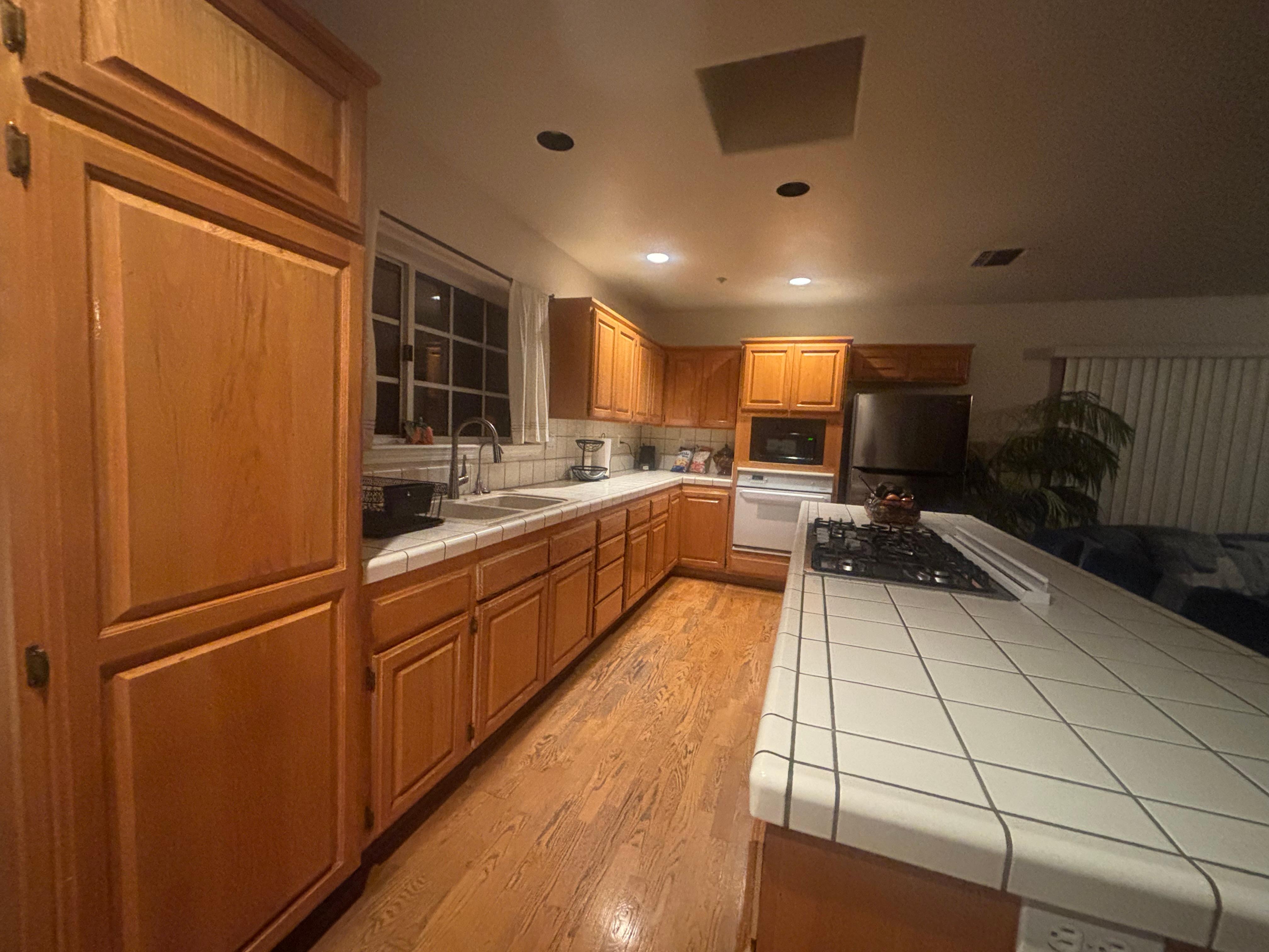 Kitchen full sink with stove top, oven, full sized refrigerator. Dishes pots pans utensils and more fully supplied. 