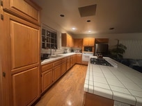 Kitchen full sink with stove top, oven, full sized refrigerator. Dishes pots pans utensils and more fully supplied.