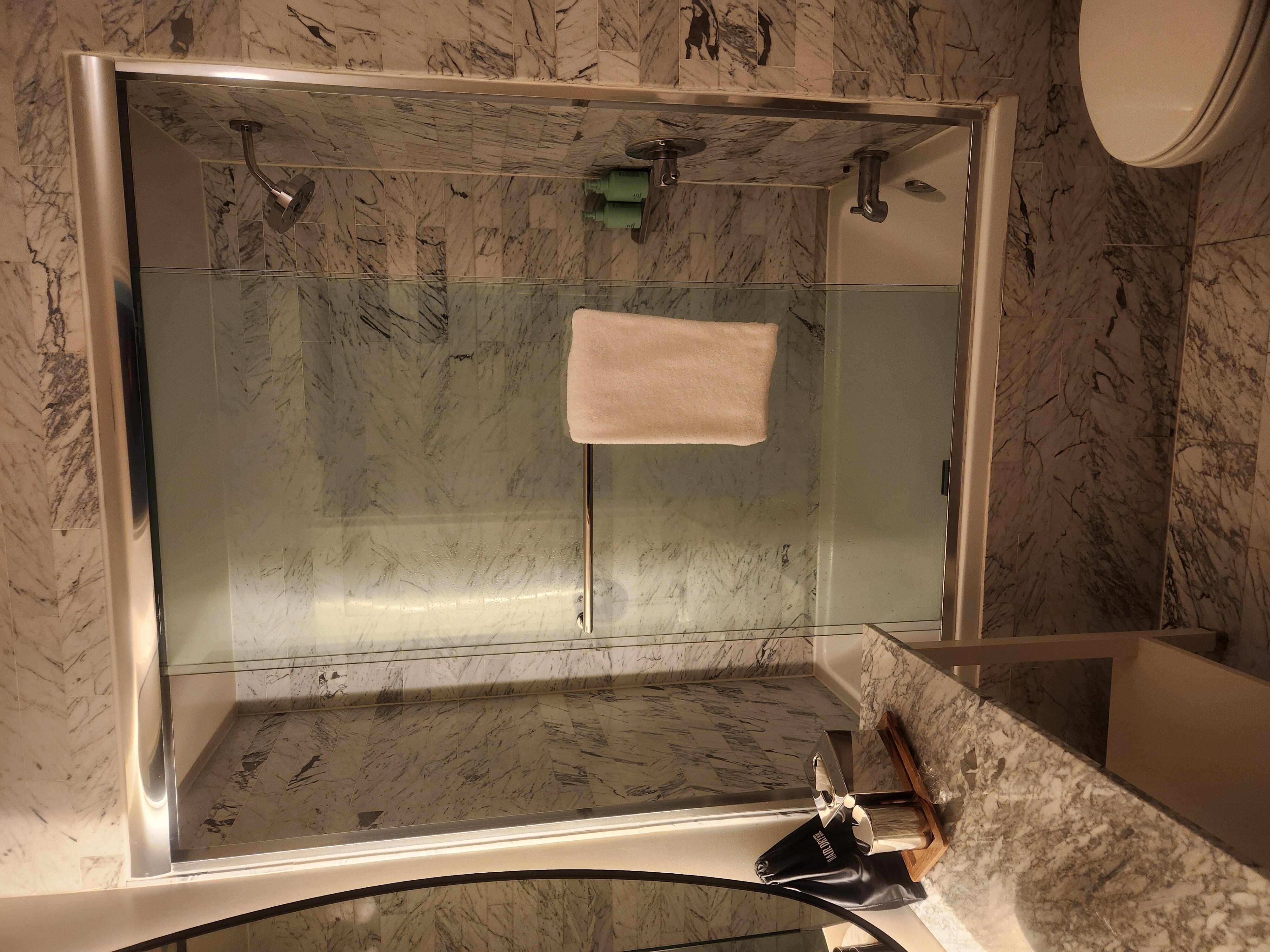 To enter the shower you either enter on the side of the shower head or step over this table. The glass door slides open somewhat further but you're still stepping over the table