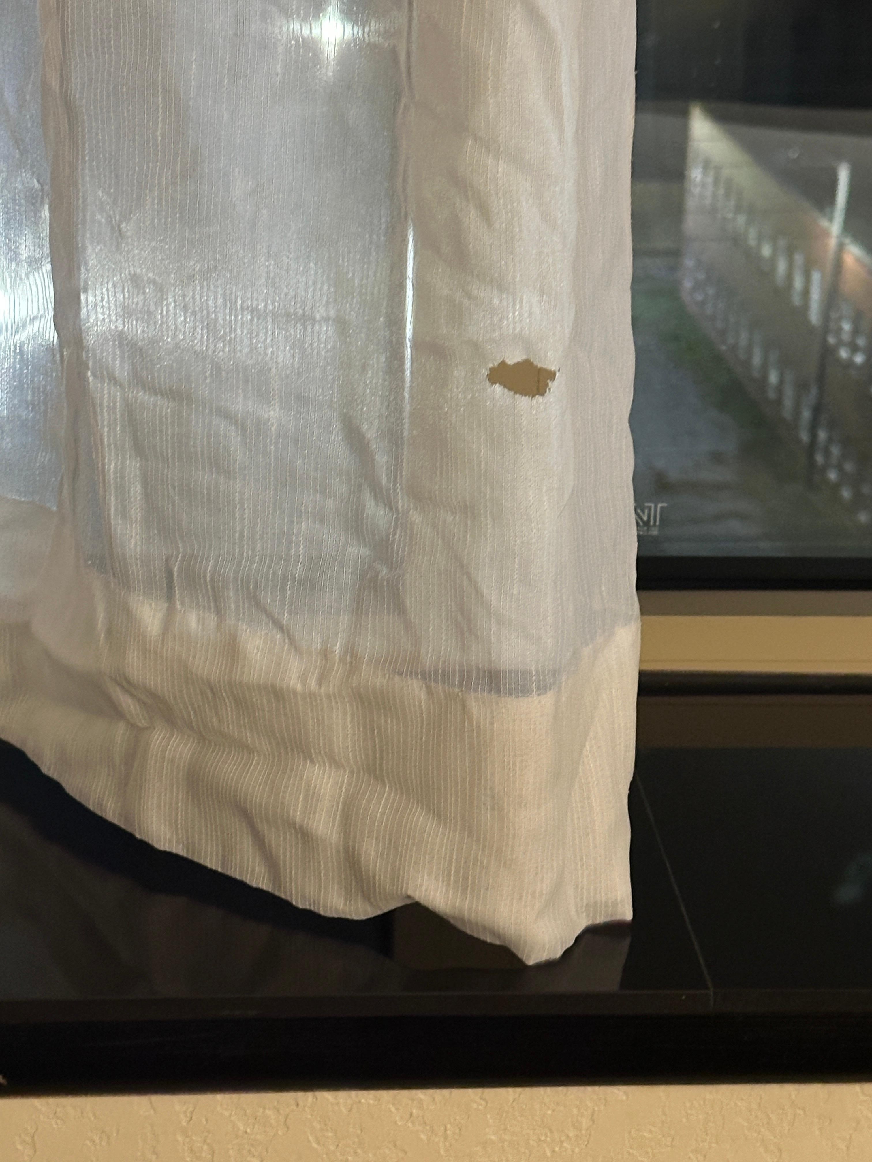 Burn hole in curtain.  Obviously not the first inconsiderate person to smoke in the rooms