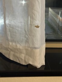 Burn hole in curtain. Obviously not the first inconsiderate person to smoke in the rooms