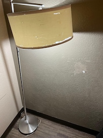 The wall needs repair and lamp needs replacing