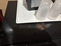Dirt on tray and fridge