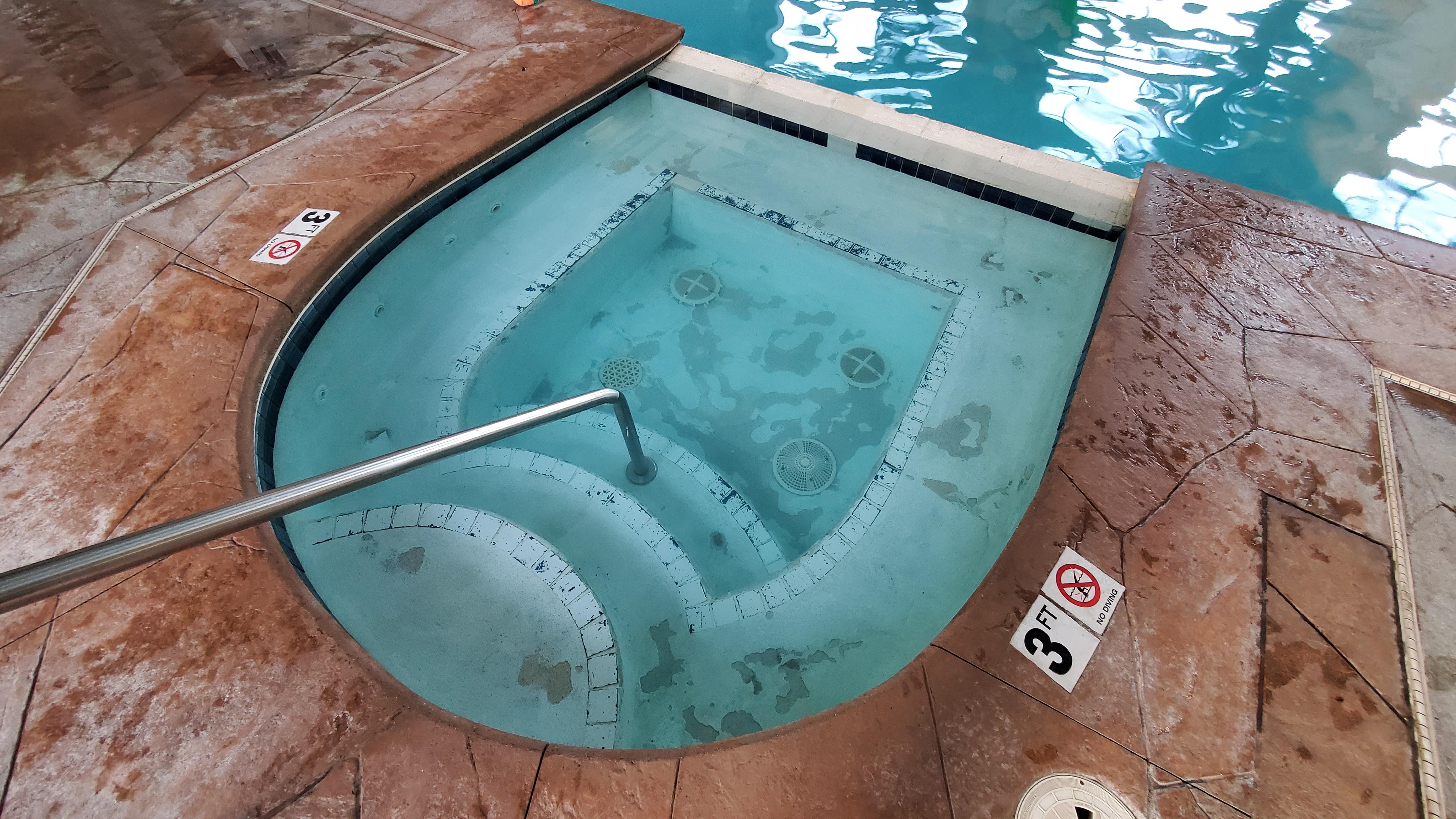 The non-working hot tub with cement popping off the floor. The pool bottom was the same, but water wasn't as clear to see it. 