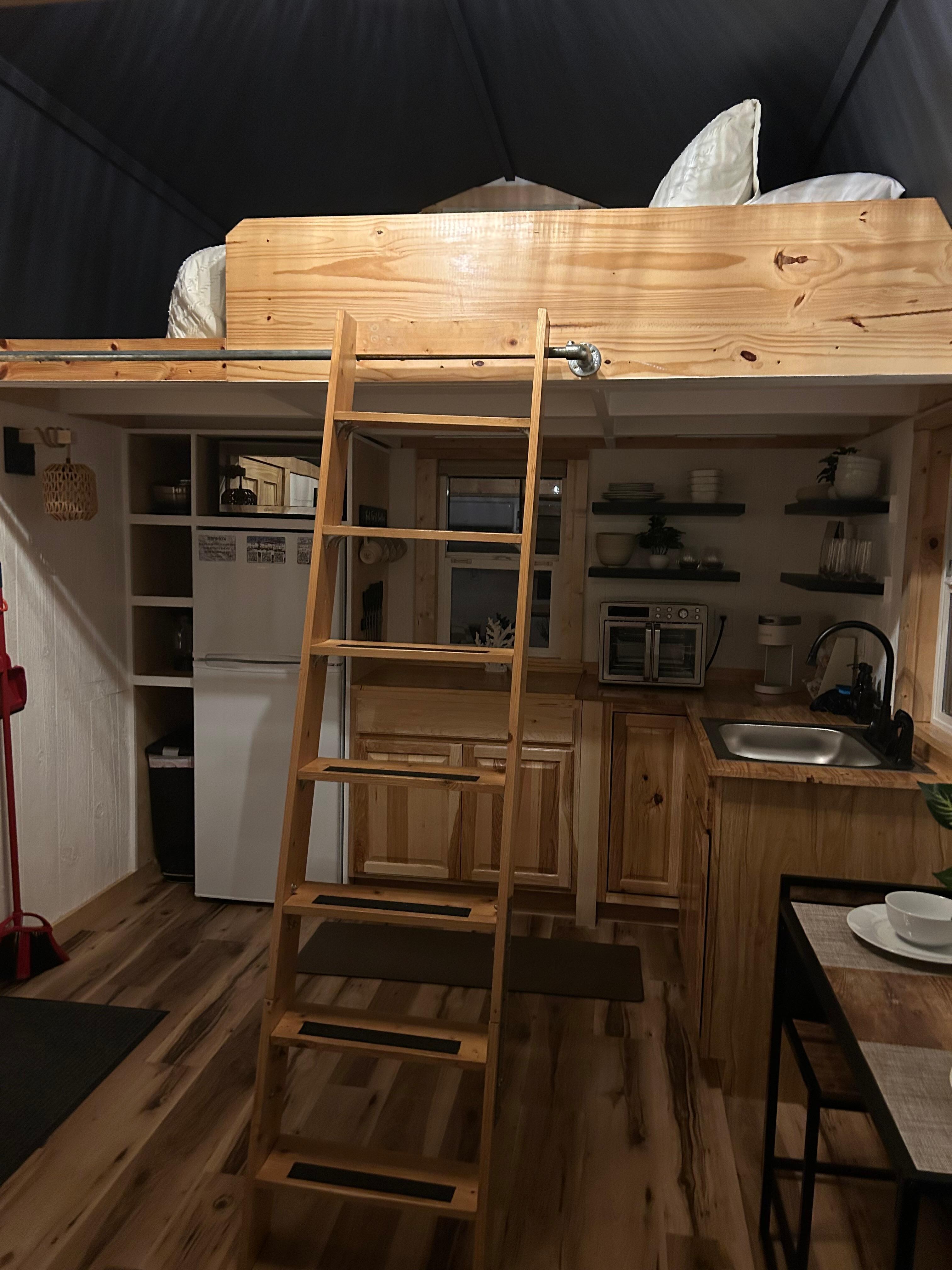 Inside view of kitchen and loft above. 