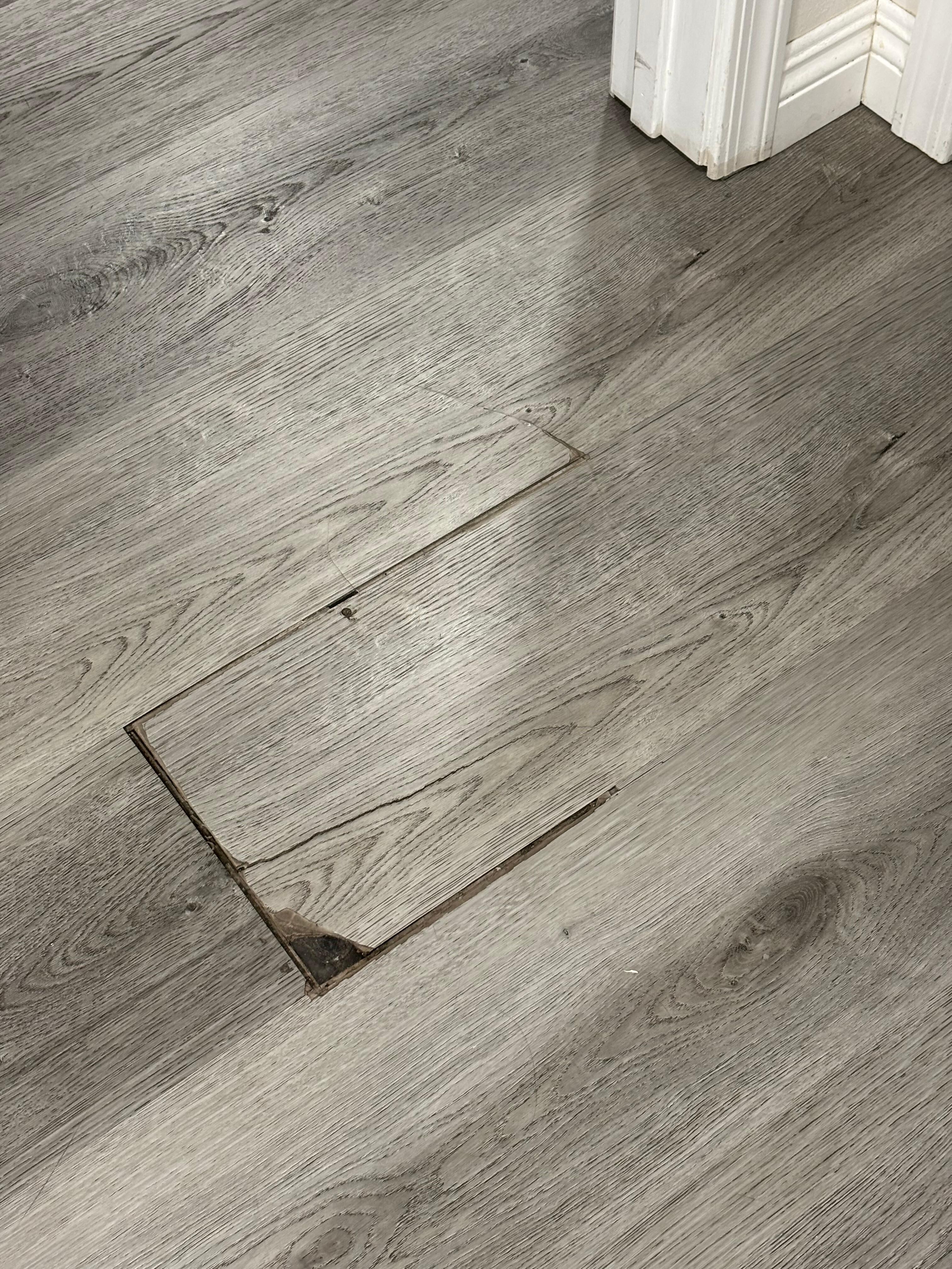 Flooring is buckled and has rough edges.