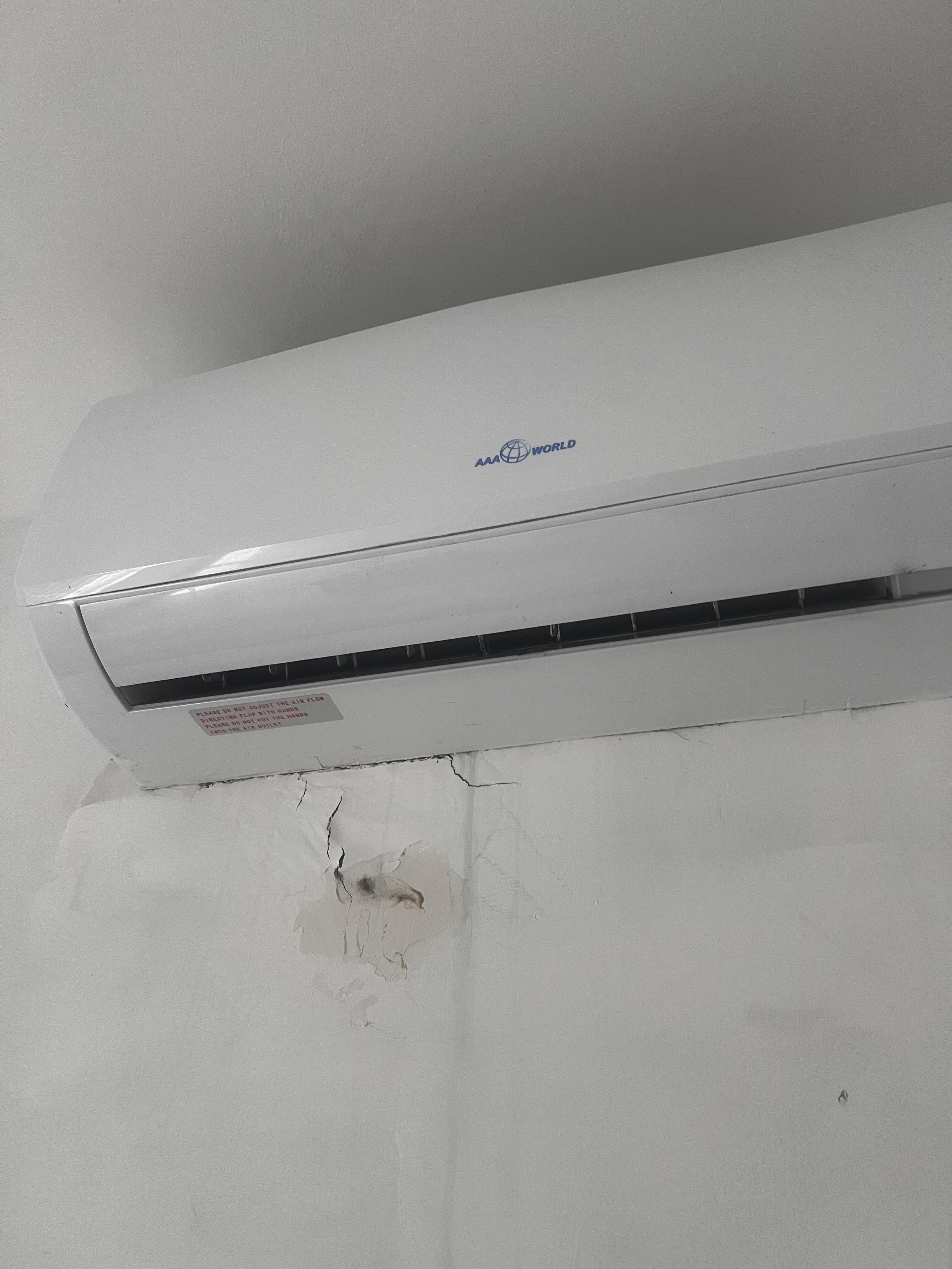 A/C in the bedroom. Visible moisture built up and mold on the wall. 