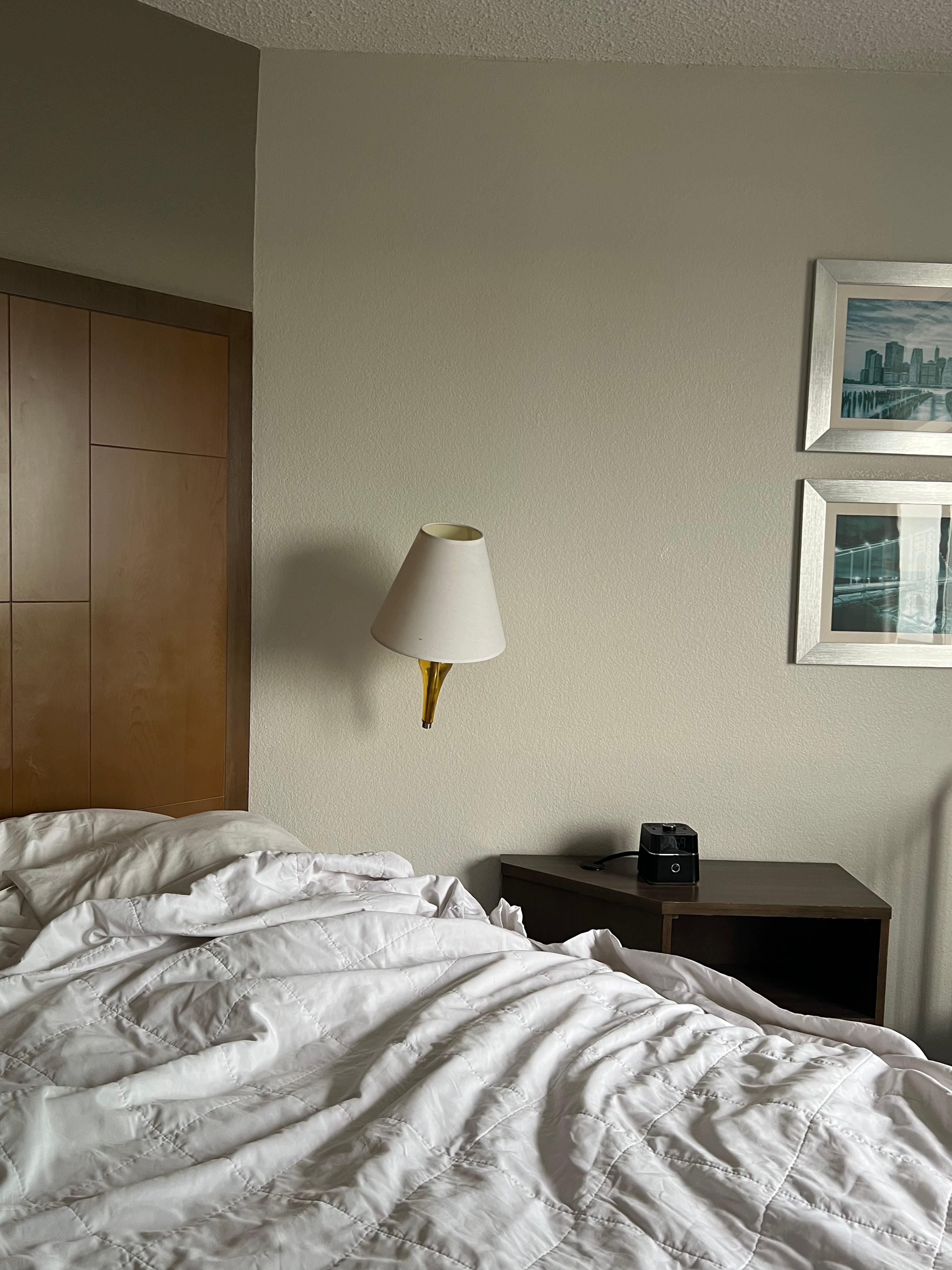 Lamp about to fall off the wall