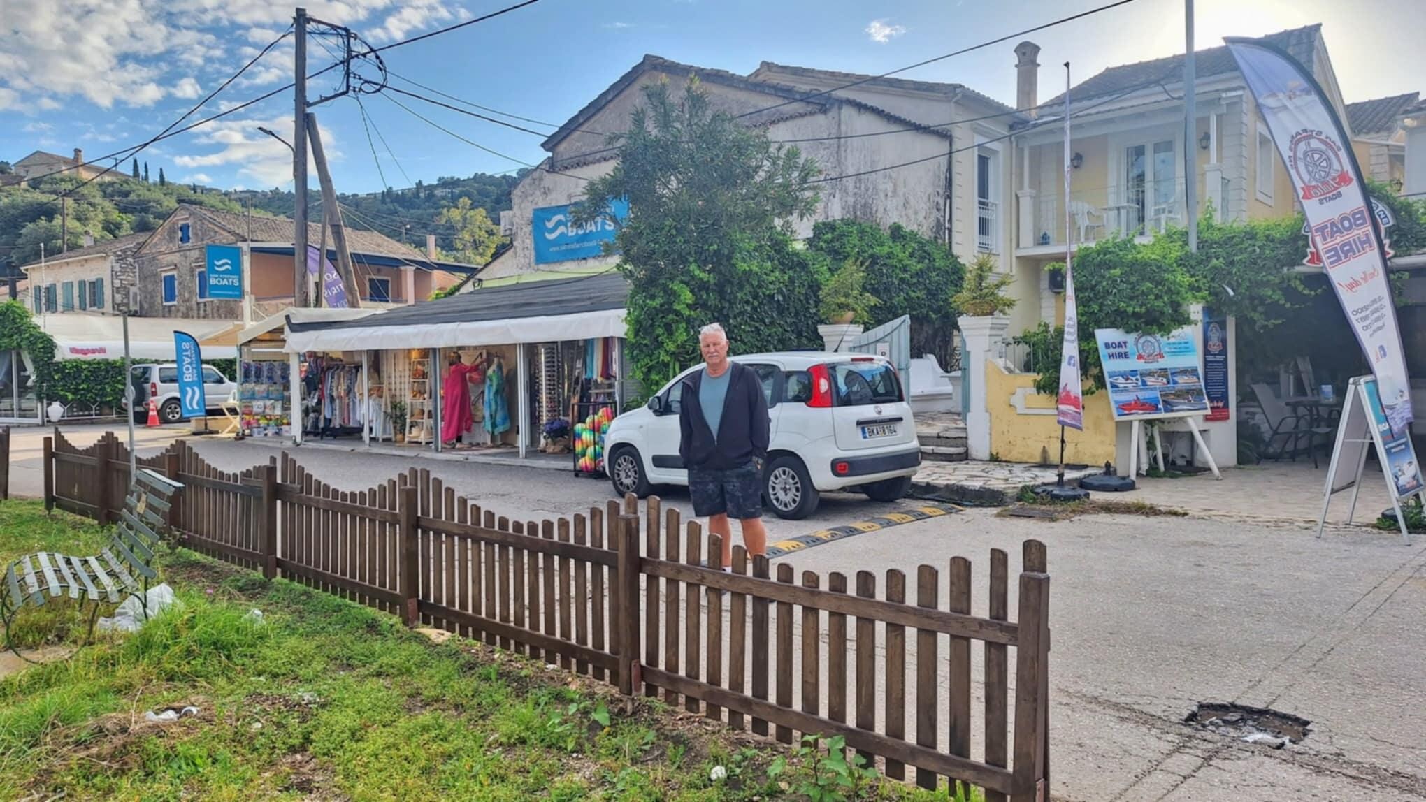 The house is tucked between a grocery store and shop
