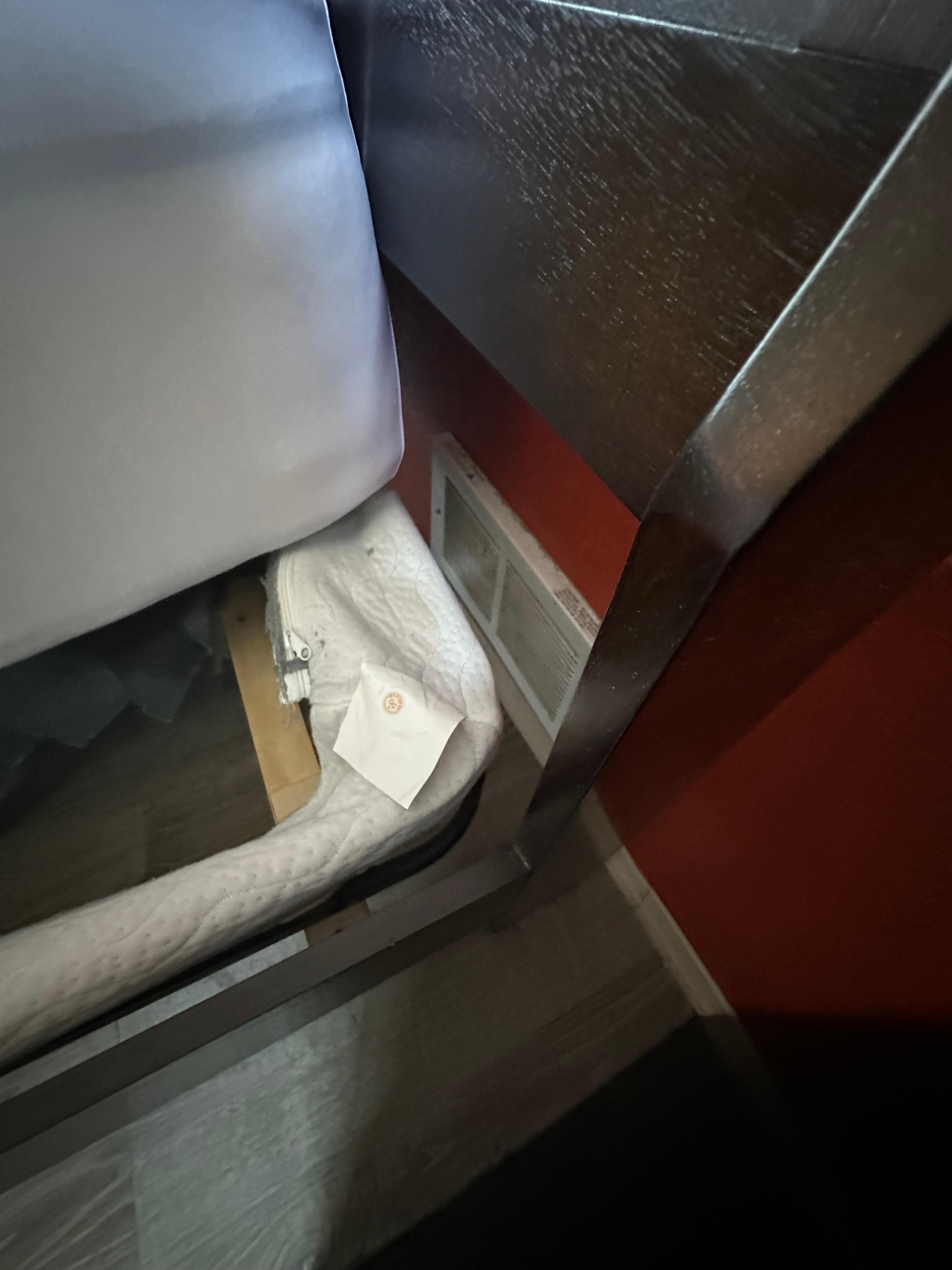 Bedroom with two full beds, one right up against heater