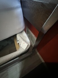 Bedroom with two full beds, one right up against heater