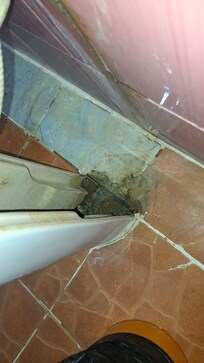 Behind the sink.